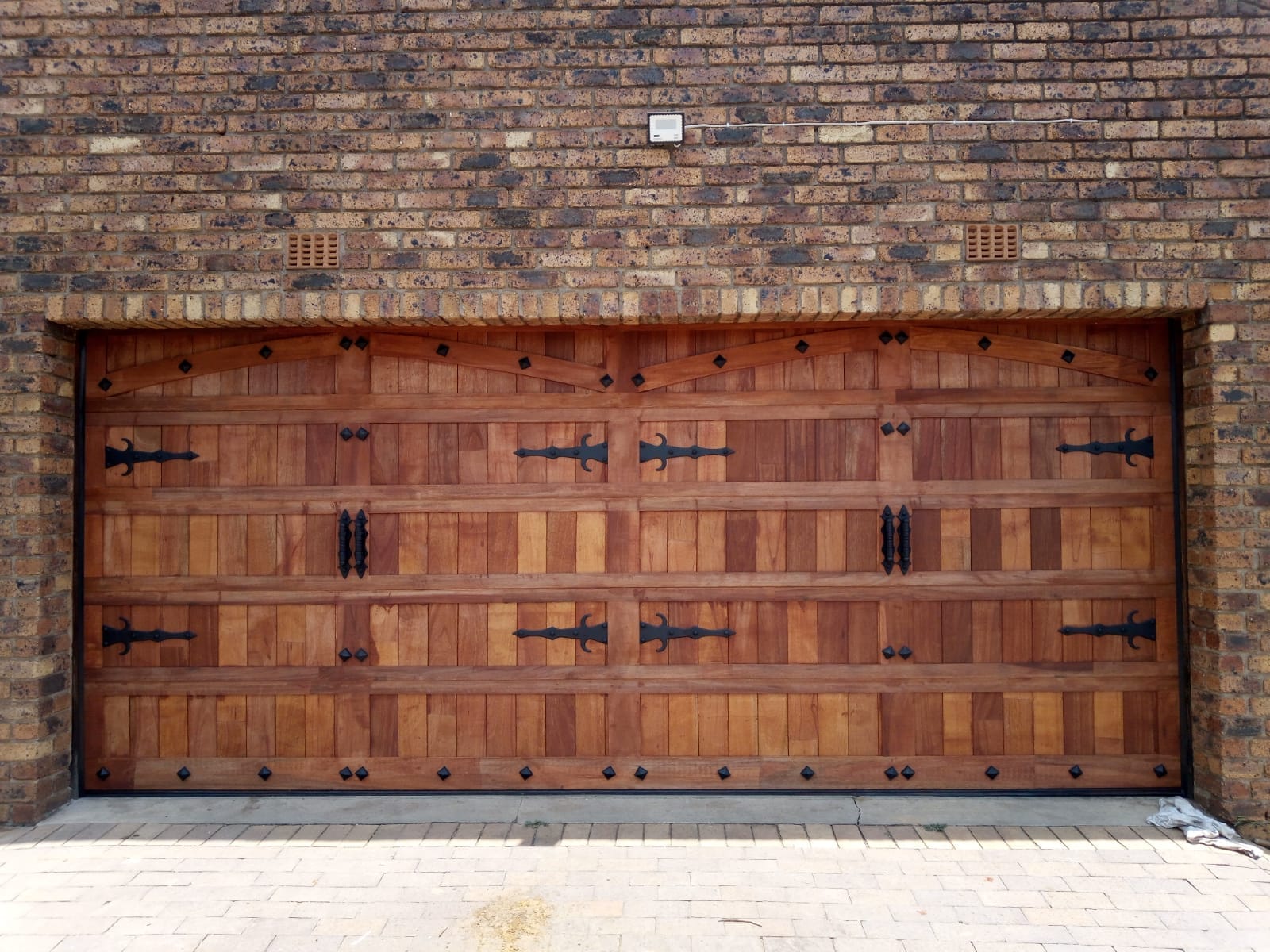 Dark Double Slatted Wooden Door - Rich wood tones for a bold and sophisticated look.